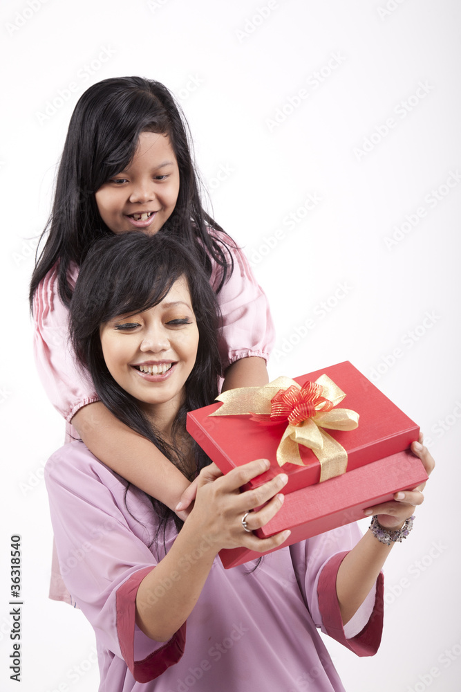 Mother opening a gift from her daughter Mother opening a gift from her daughter