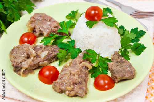 Liver fried with onion, rice and tomato cherry