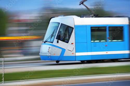 Modern blue tram rider fast on rails, Wroclaw, Poland