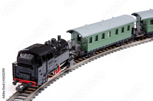 Toy steam train pusing two carriages