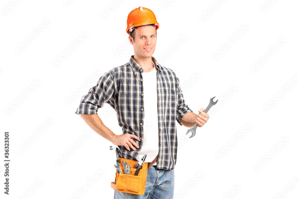 A confident and smiling handyman holding a wrench A confident and smiling handyman holding a wrench