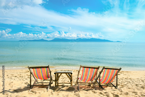 Chairs on the sandy beach near with sea © Andrii Vergeles