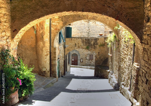 Arch in the street of an old village, Italy photo