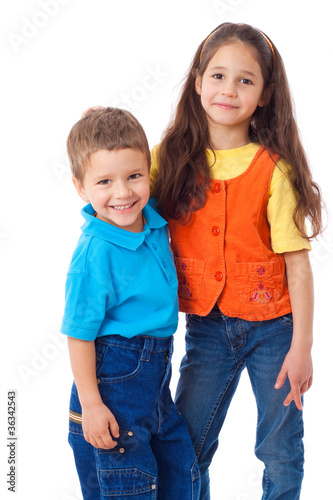 Two smiling little children standing together