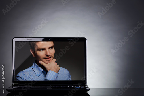 man on the screen of a laptop