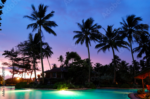Sunset and illuminated swimming pool, Bentota, Sri Lanka © slava296
