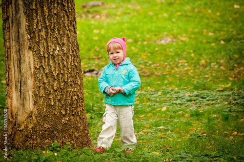 Cute child walking in autumn park