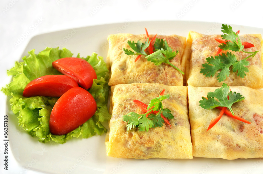 A delicious omelet with ham and tomato