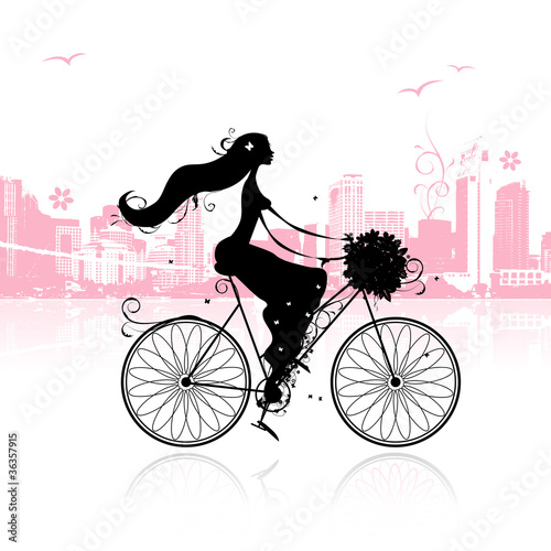 Girl with floral bouquet cycling in the city