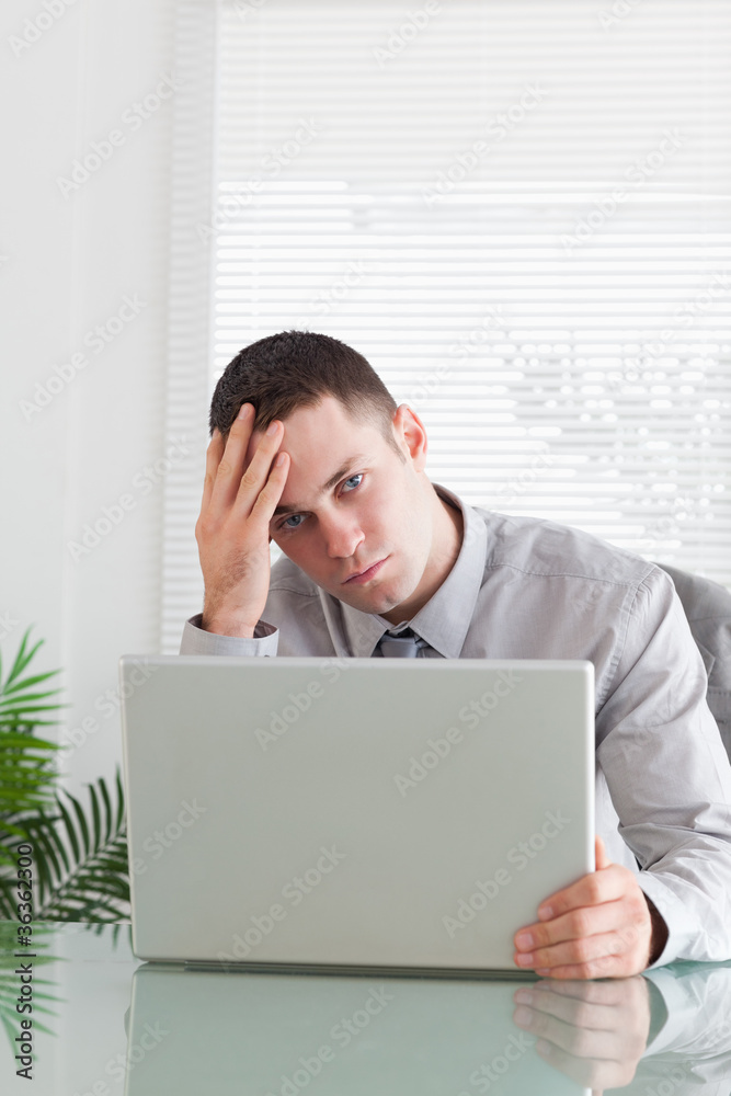 Close up of businessman having a problem with his laptop Close up of businessman having a problem with his laptop