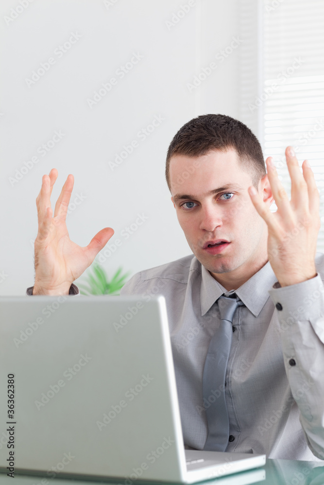 Close up of young businessman having problems with his notebook Close up of young businessman having problems with his notebook