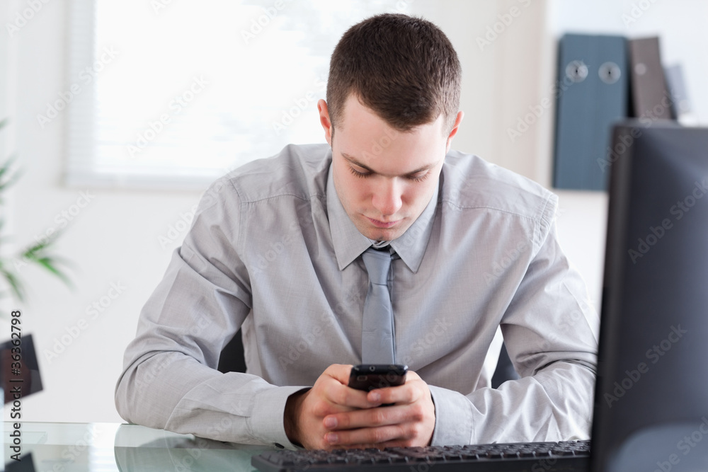 Businessman writing a textmessage Businessman writing a textmessage