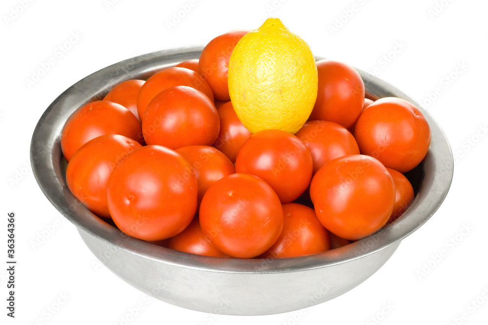 Tomatoes and lemon  in a bowl