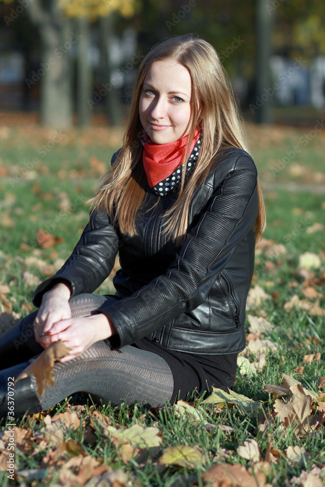 Beautiful young woman in autumn park
