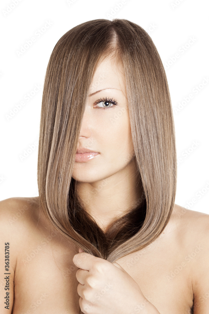 Fototapeta premium young beautiful woman holding her beautiful long natural hair