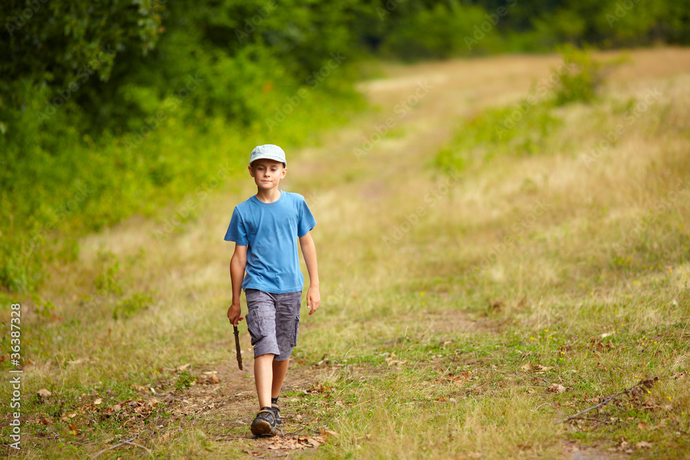 Boy walking in a forest