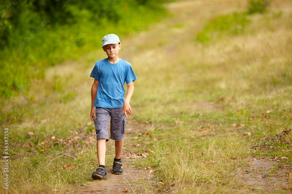 Boy walking in a forest