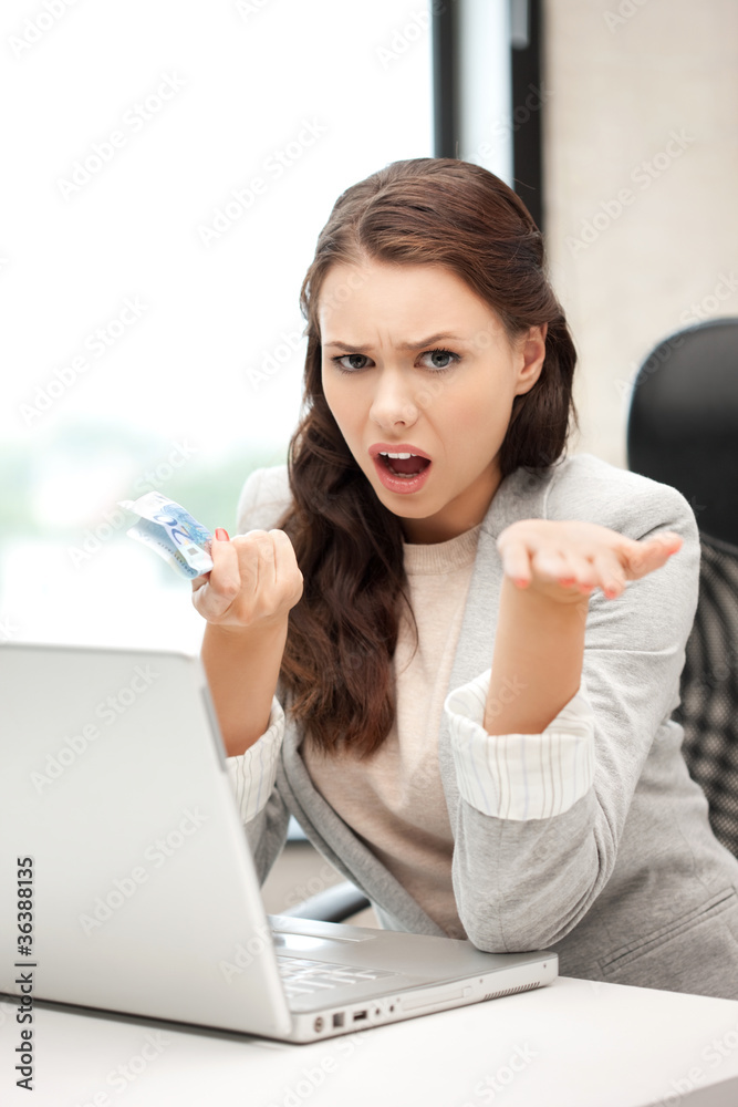 unhappy woman with computer and euro cash money unhappy woman with computer and euro cash money