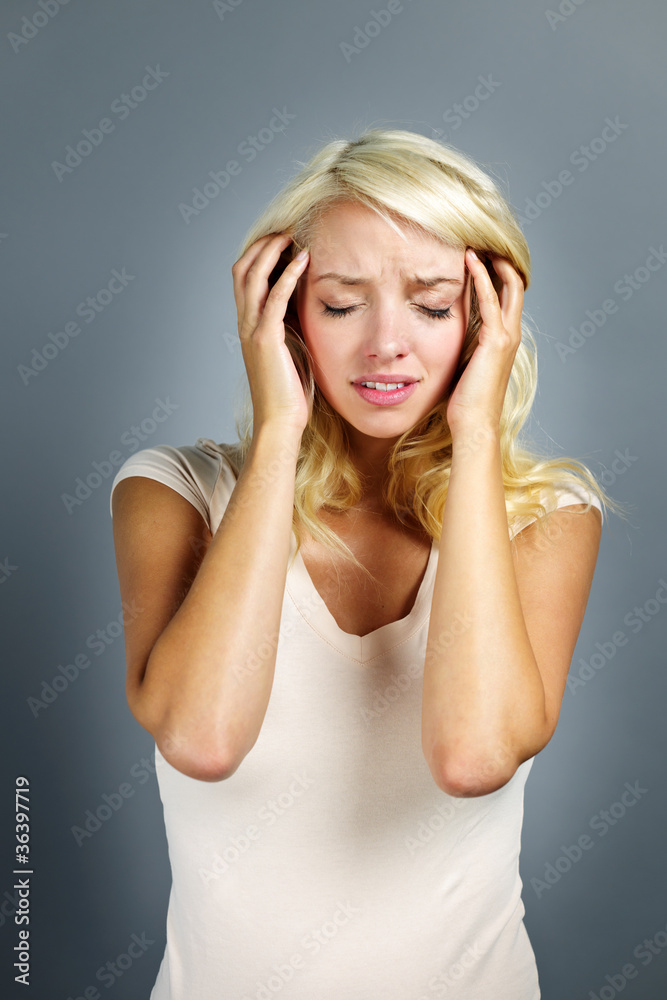Unhappy woman holding her head Unhappy woman holding her head