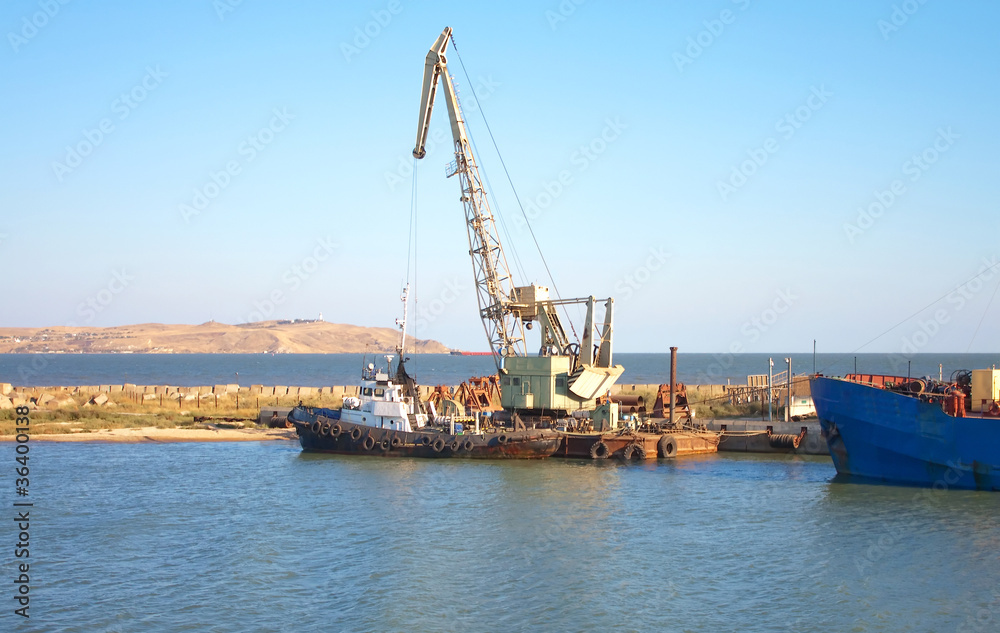 small ship and crane in dock