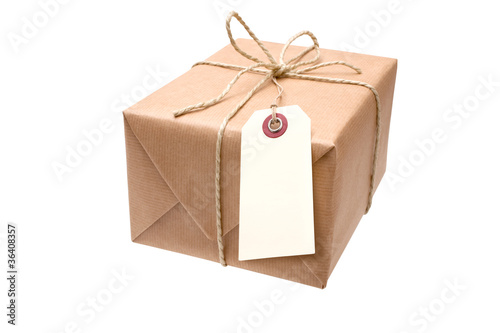 brown paper parcel with a blank luggage tag