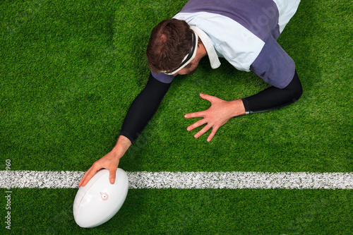 Εκτύπωση καμβά Rugby player scoring a try with one hand on the ball