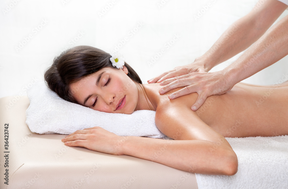 Beautiful brunette woman getting a back massage Beautiful brunette woman getting a back massage