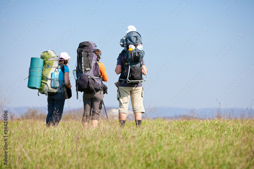 Father is hiking with the 1.5 year baby in baby carrier Father is hiking with the 1.5 year baby in baby carrier
