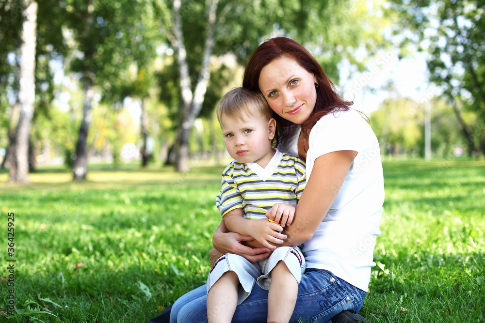 Young mother with her son in summer park Young mother with her son in summer park