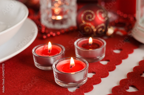christmas table - candles and decoration on red