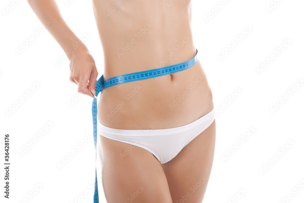 woman measuring size of her waist with a tape measure