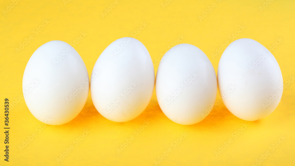 Eggs isolated on yellow background Eggs isolated on yellow background