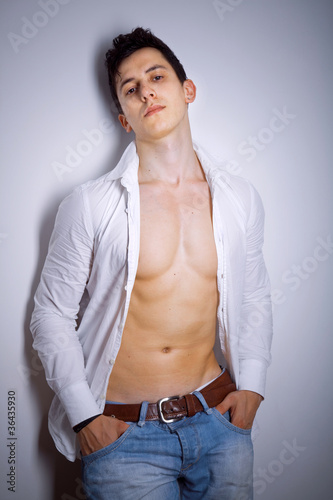 Style photo of a young man posing against grey background