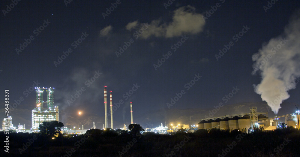 Petrochemical refinery at night with full moon light