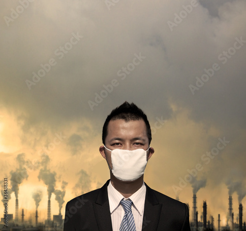 sad bussinessman with mask and air pollution concept