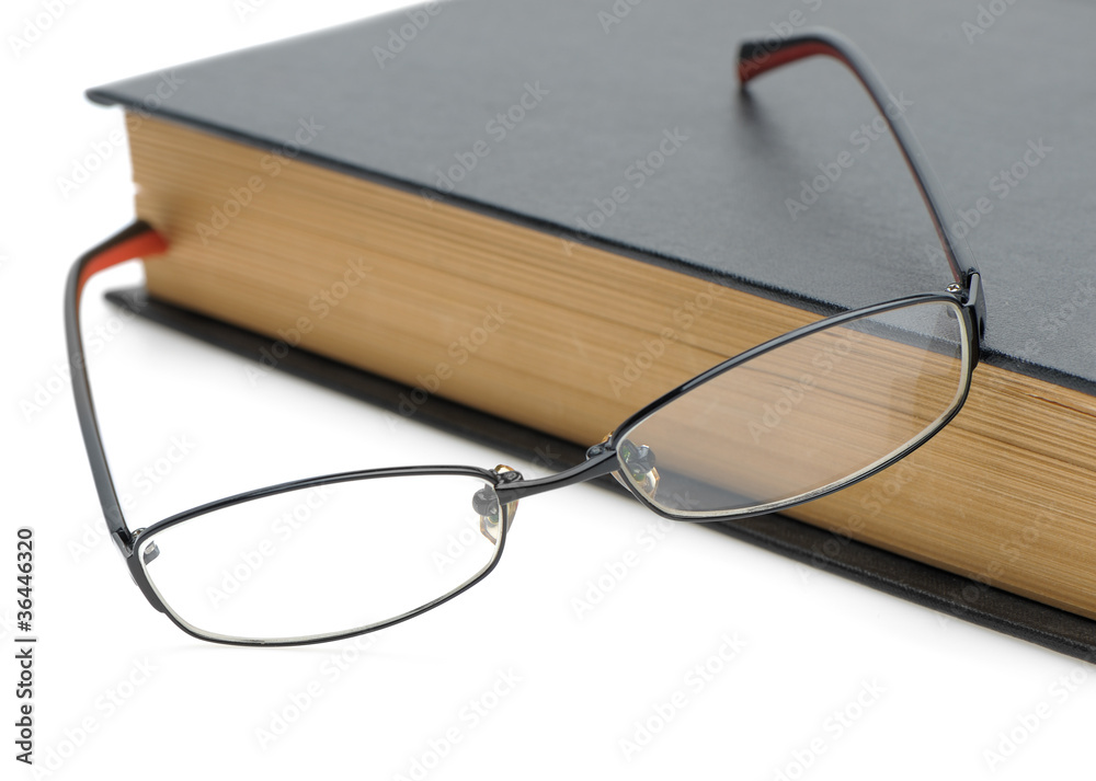 Eyeglasses on the old thick book Eyeglasses on the old thick book