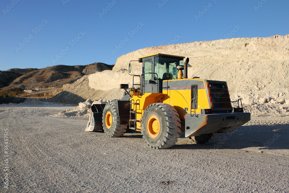 Back side of working loader at the construction zone Back side of working loader at the construction zone