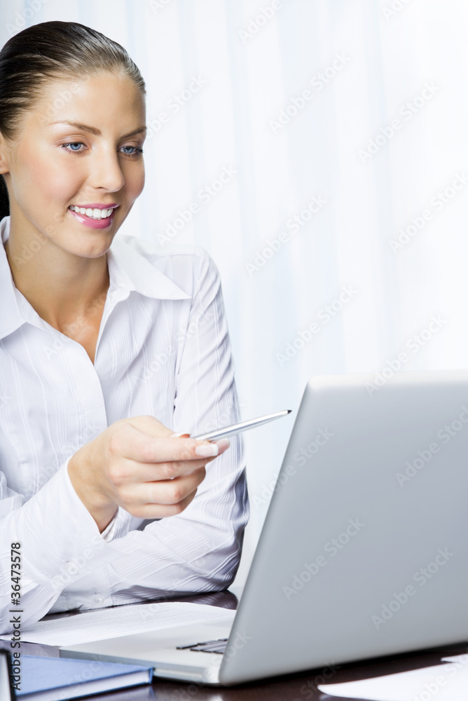 Happy smiling businesswoman working with laptop Happy smiling businesswoman working with laptop