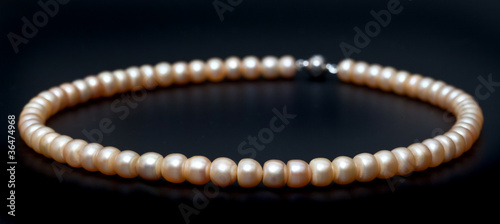 Freshwater pearl necklace on the black background