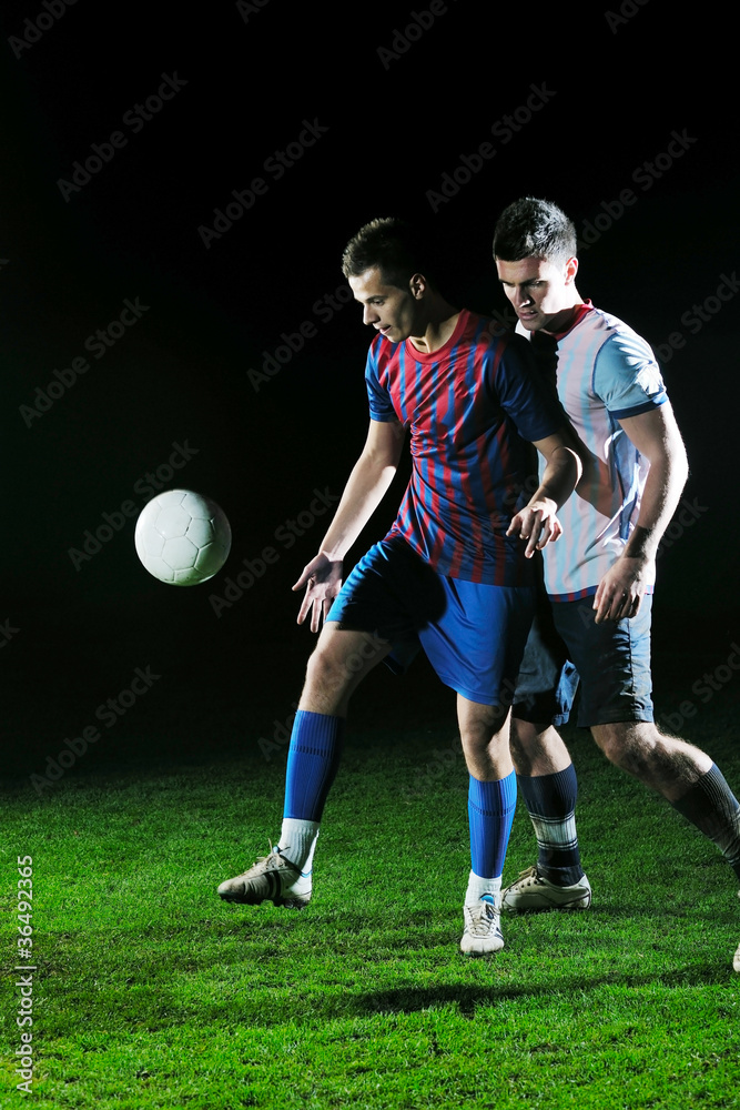 football players in competition for the ball