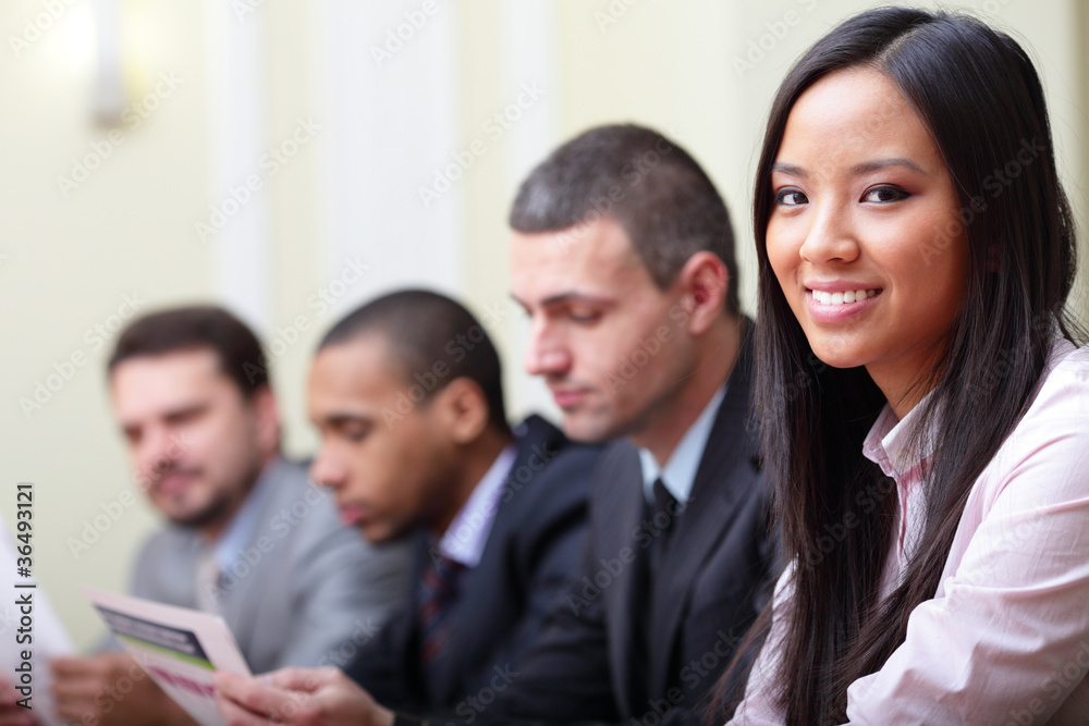 Multi ethnic business executives working with documents