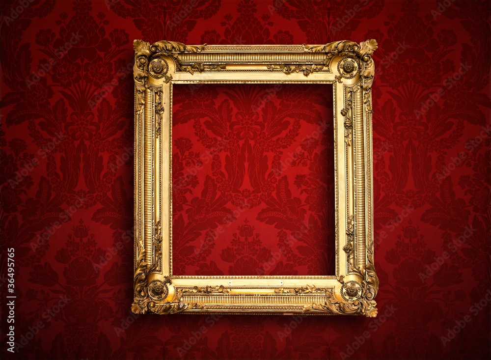 Fototapeta premium Empty golden painting frame on vintage wallpaper