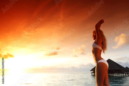 woman in a dress on maldivian sunset