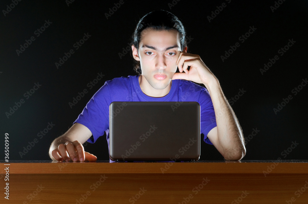 Hacker sitting in dark room Hacker sitting in dark room
