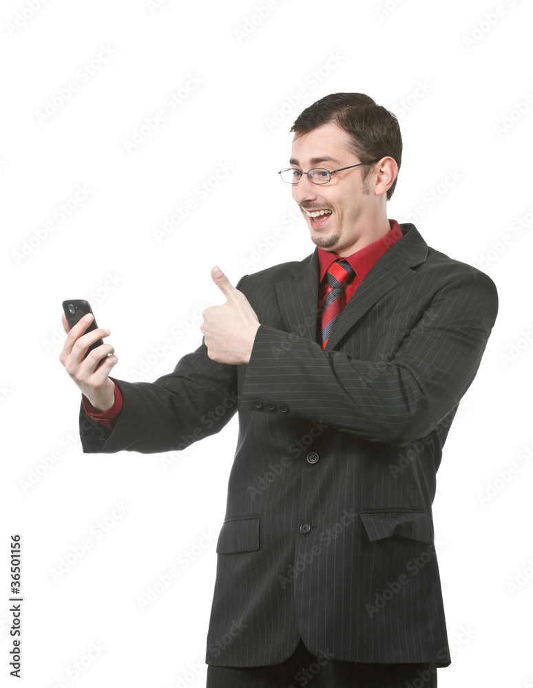 Happy businessman shows thumb on a cell phone Happy businessman shows thumb on a cell phone