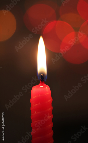 red candle on dark background