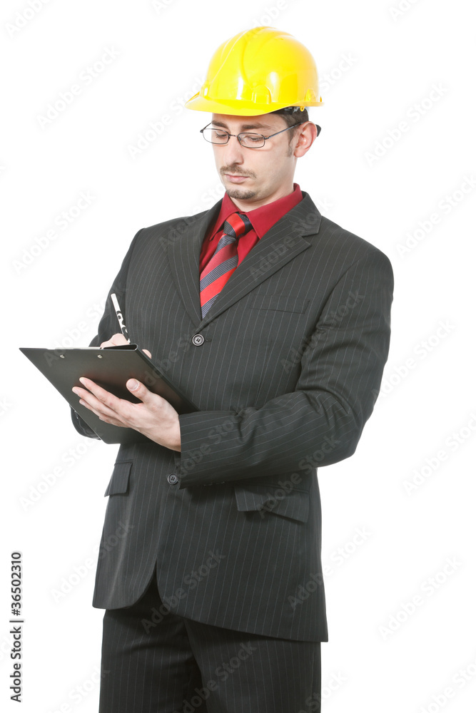 Young engineer with hard hat taking notes Young engineer with hard hat taking notes