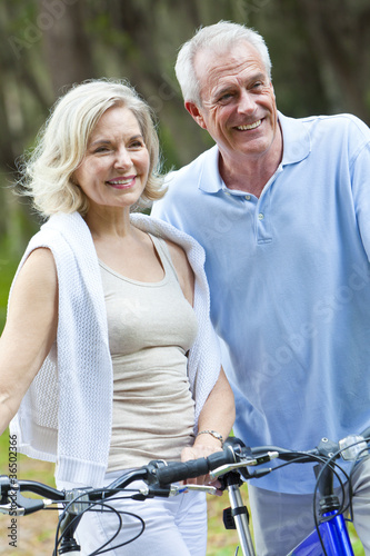 Happy Senior Man & Woman Couple Cycling Bicycles