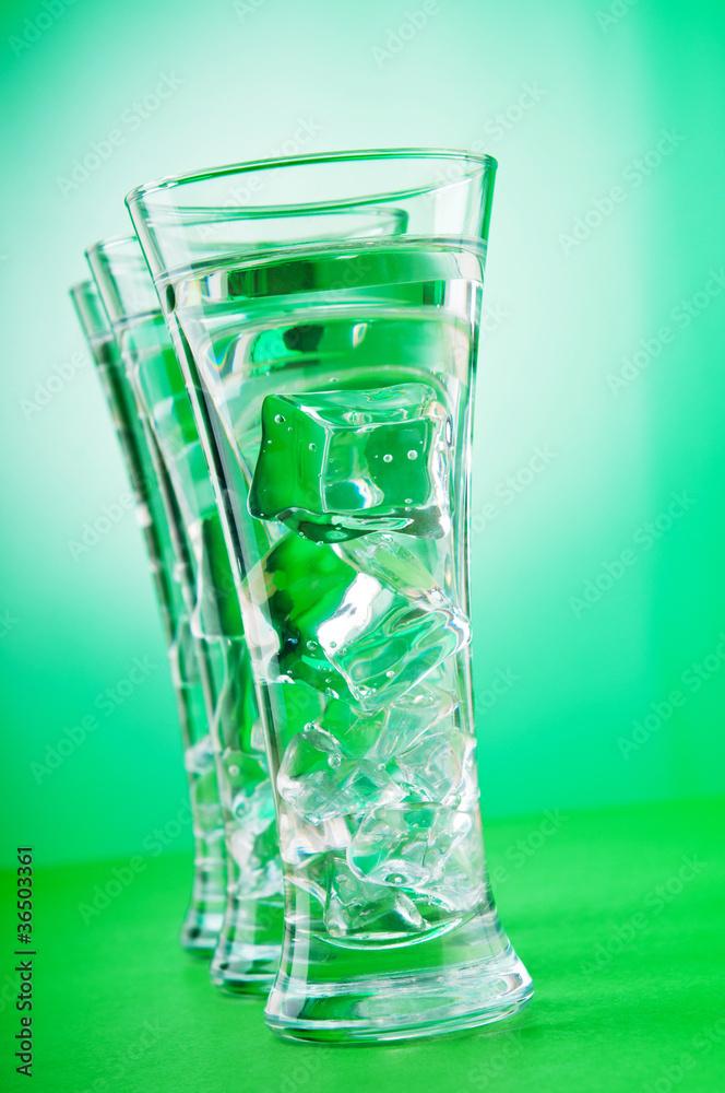 Water in the glass against gradient background Water in the glass against gradient background