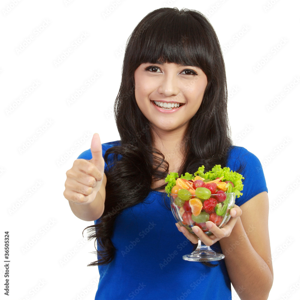 Young beautiful woman holding huge glass of fruits Young beautiful woman holding huge glass of fruits